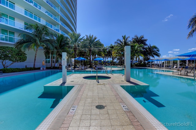 view of swimming pool featuring a community hot tub