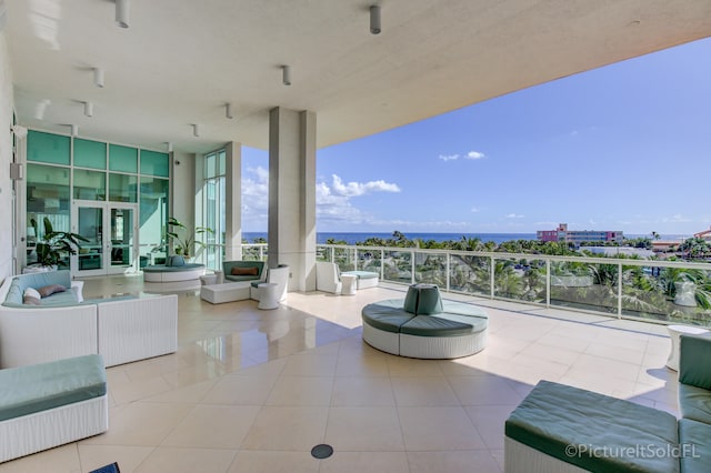 view of patio with a balcony and a water view