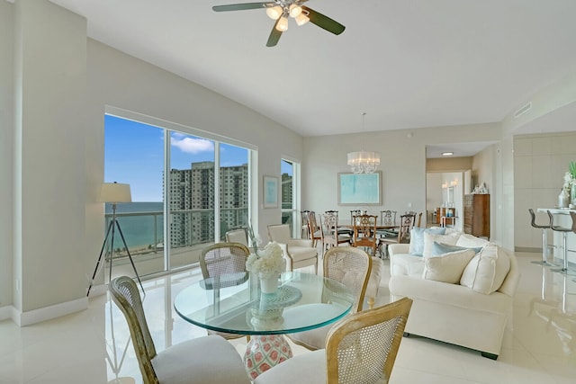 dining space featuring ceiling fan with notable chandelier and light tile patterned floors