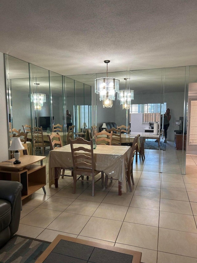 dining area featuring a textured ceiling and tile patterned flooring