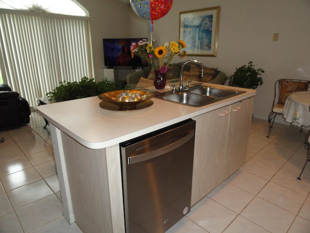 kitchen featuring light tile patterned floors, sink, stainless steel dishwasher, and a center island with sink