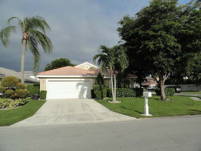 view of front of property with a front lawn and a garage