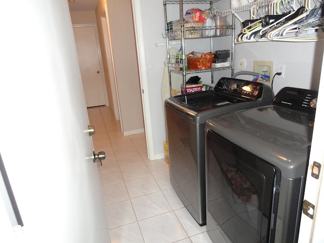 washroom with washer and dryer and light tile patterned flooring