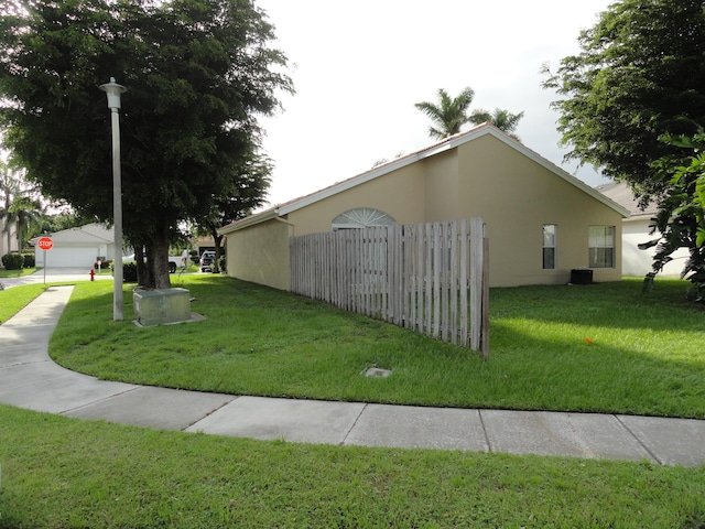 view of home's exterior featuring central AC and a lawn