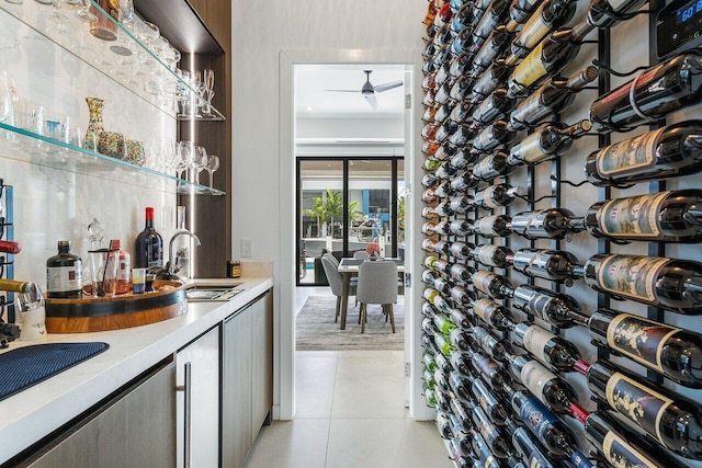 wine room with sink, light tile patterned flooring, and ceiling fan