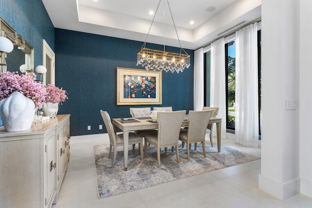 dining space with a raised ceiling