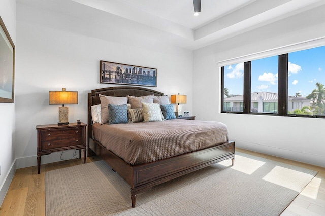 bedroom with ceiling fan and light hardwood / wood-style flooring