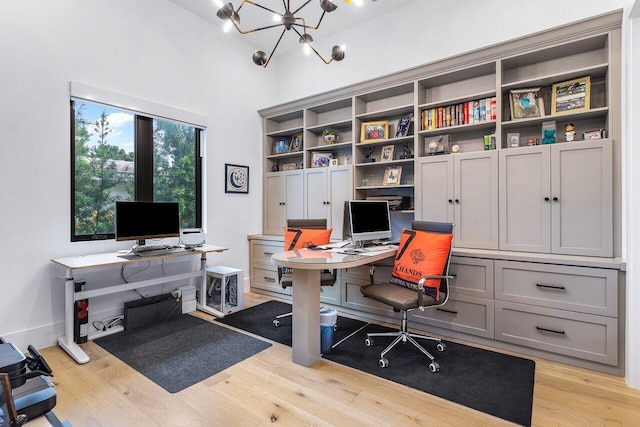 office space featuring a chandelier and light hardwood / wood-style floors