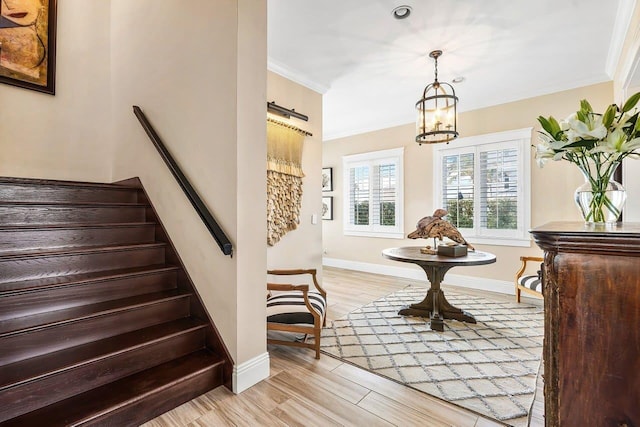 interior space featuring hardwood / wood-style floors, crown molding, and a chandelier