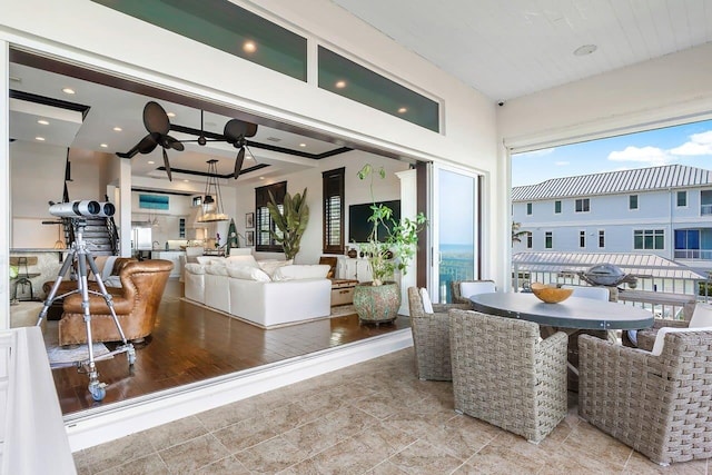 living room featuring light hardwood / wood-style floors and ceiling fan