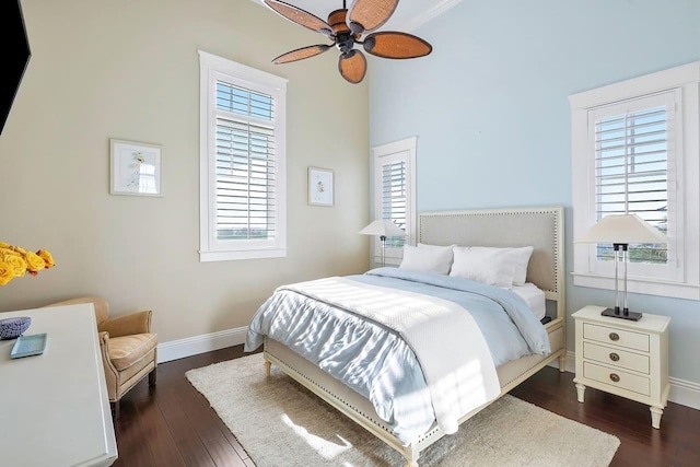 bedroom with dark hardwood / wood-style flooring and ceiling fan