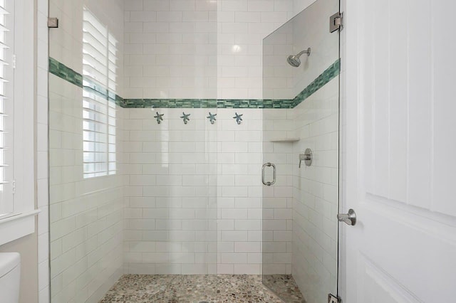 bathroom with an enclosed shower and toilet