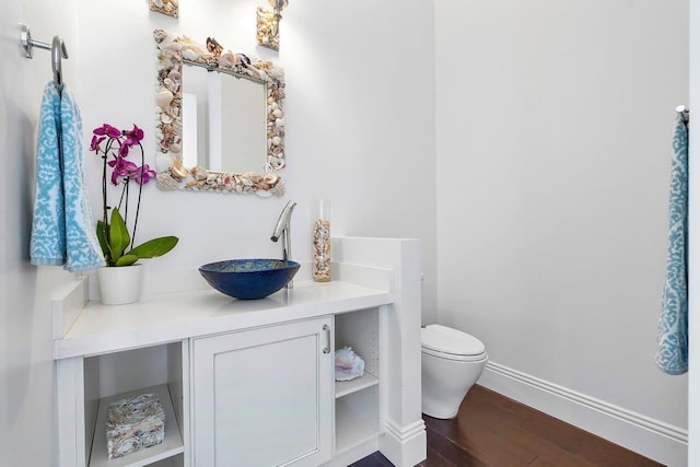 bathroom featuring hardwood / wood-style floors, vanity, and toilet