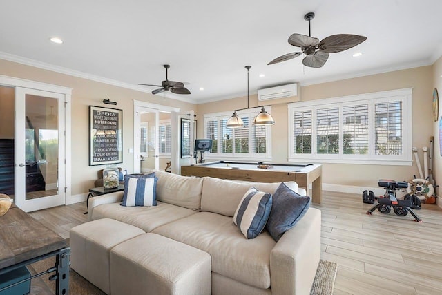 living room featuring a wall mounted AC, french doors, and light hardwood / wood-style floors