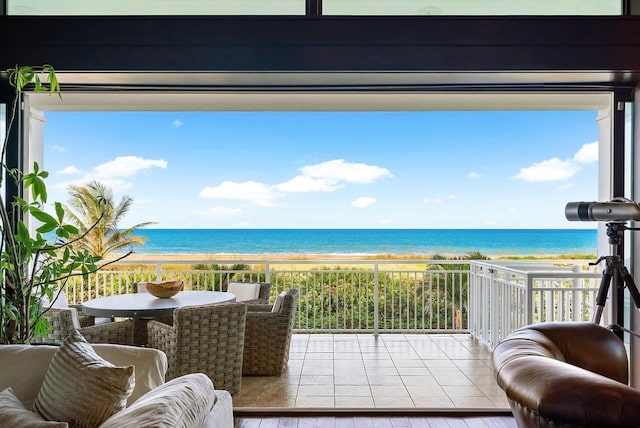 balcony featuring a water view and a view of the beach