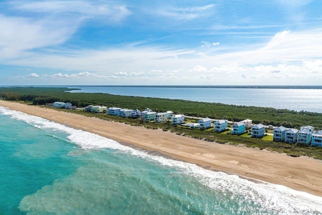 drone / aerial view with a water view and a beach view