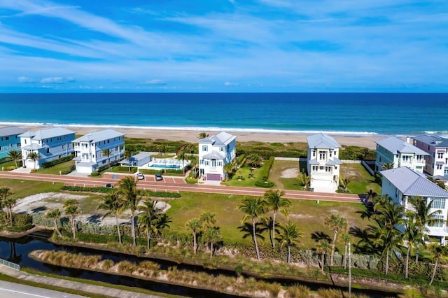 bird's eye view with a water view and a beach view