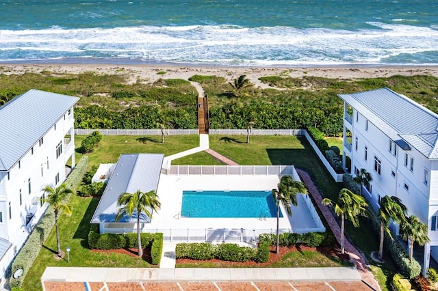 drone / aerial view featuring a beach view and a water view