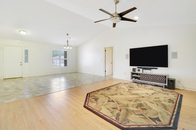 living room with lofted ceiling, ceiling fan with notable chandelier, and light wood-type flooring