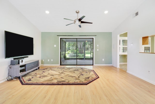 living room featuring vaulted ceiling, light hardwood / wood-style flooring, and ceiling fan