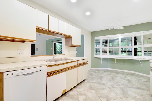 kitchen with white cabinetry, ceiling fan, white dishwasher, and sink