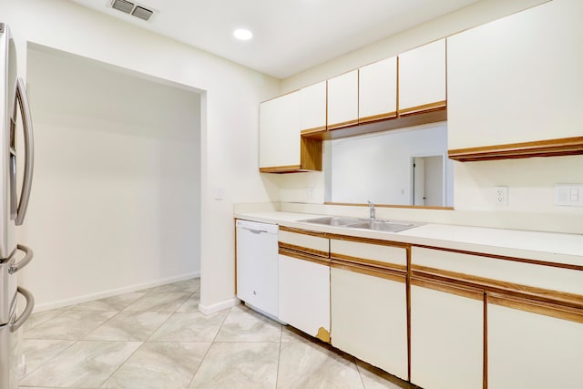 kitchen with stainless steel refrigerator with ice dispenser, white dishwasher, sink, and white cabinets