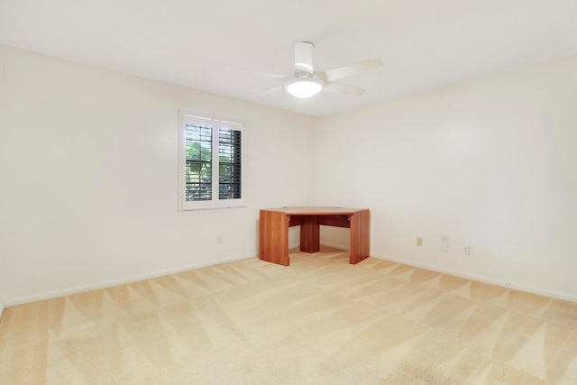 spare room featuring light carpet and ceiling fan