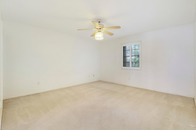 empty room featuring light carpet and ceiling fan