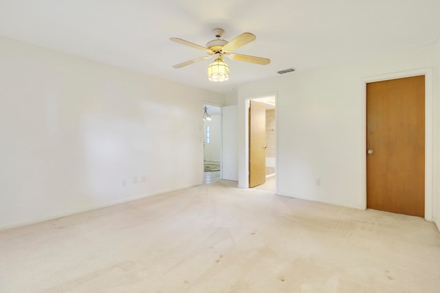 empty room featuring light carpet and ceiling fan