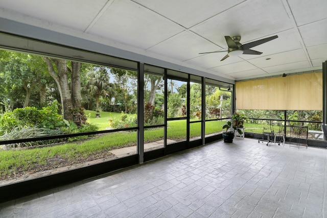 unfurnished sunroom featuring ceiling fan