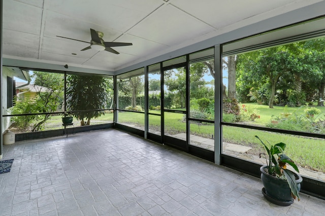 unfurnished sunroom featuring ceiling fan