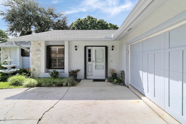 view of exterior entry with a garage