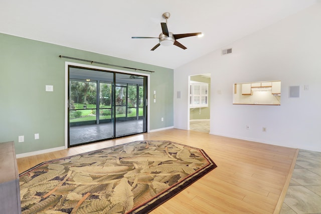 empty room featuring hardwood / wood-style floors, ceiling fan, and vaulted ceiling