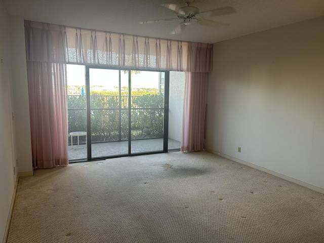 11370 Twelve Oaks Way Unit 117, North Palm Beach, FL 33408 - carpeted empty room with a ceiling fan and baseboards