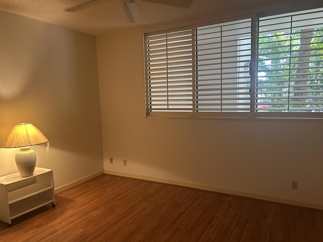 11370 Twelve Oaks Way Unit 117, North Palm Beach, FL 33408 - empty room featuring plenty of natural light, a ceiling fan, wood finished floors, and baseboards