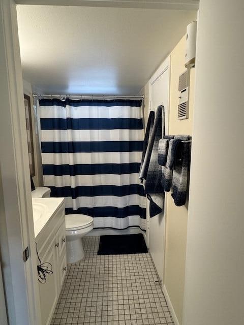 bathroom with vanity, toilet, tile patterned flooring, and a shower with shower curtain