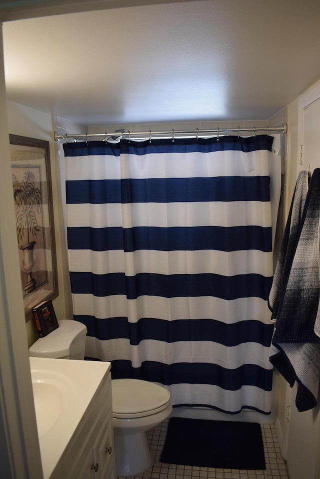 bathroom with vanity, curtained shower, toilet, and tile patterned flooring