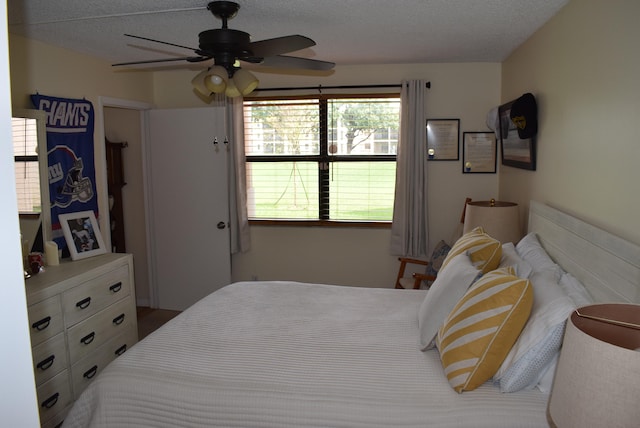 bedroom featuring ceiling fan and a textured ceiling