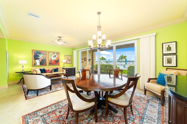 dining space featuring ornamental molding, light tile patterned flooring, and ceiling fan with notable chandelier