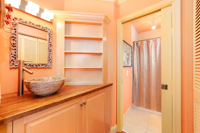 bathroom featuring vanity, a shower with curtain, and tile patterned flooring