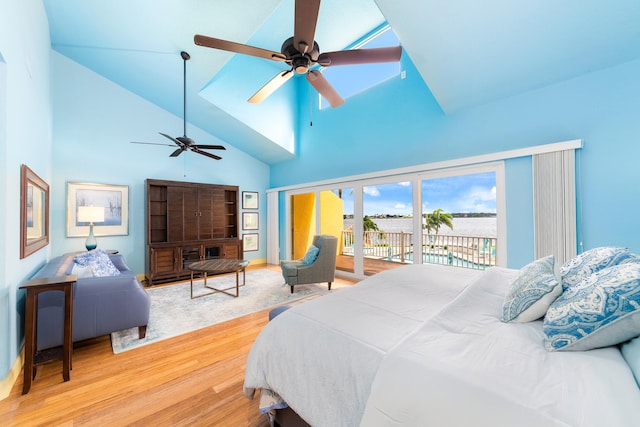 bedroom featuring access to exterior, hardwood / wood-style flooring, high vaulted ceiling, and ceiling fan