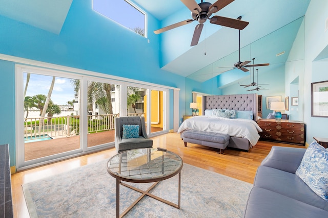 bedroom featuring high vaulted ceiling, hardwood / wood-style flooring, access to outside, and ceiling fan