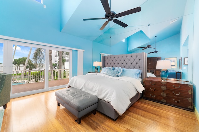 bedroom featuring light hardwood / wood-style flooring, access to exterior, high vaulted ceiling, and ceiling fan