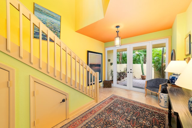 foyer featuring french doors and light tile patterned floors