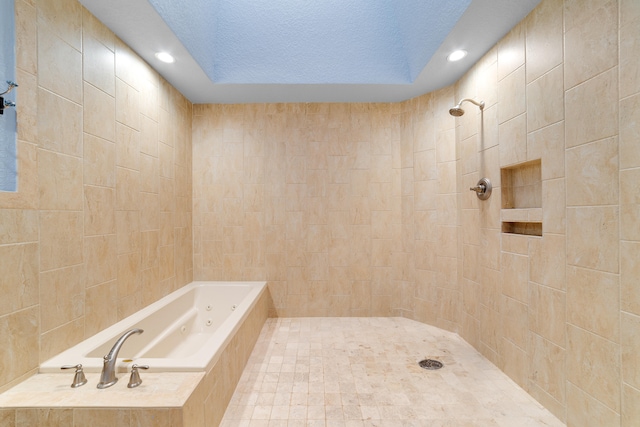 bathroom featuring tile walls, independent shower and bath, and a textured ceiling