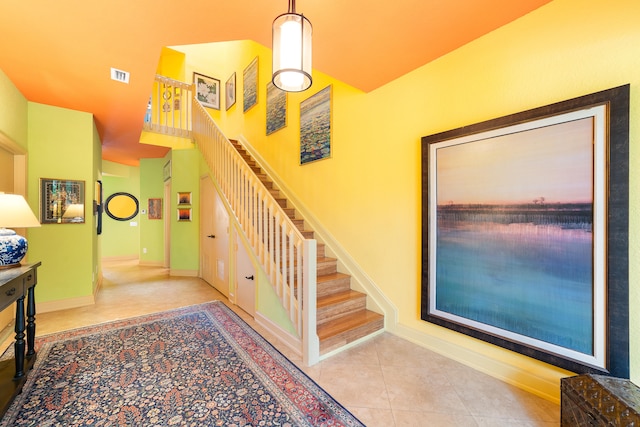 stairway with tile patterned flooring