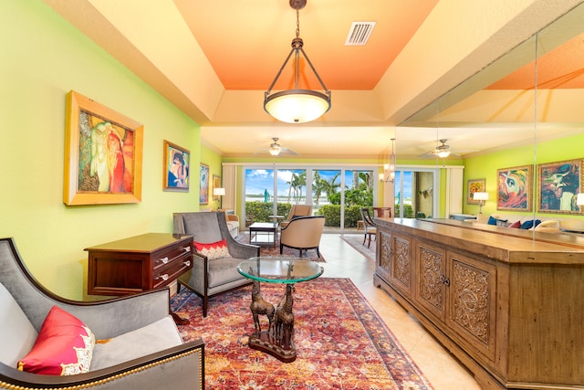 interior space with light tile patterned flooring, a tray ceiling, and ceiling fan