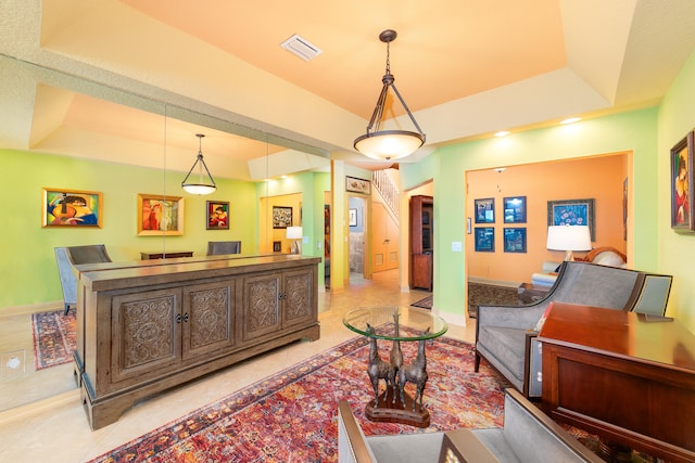 tiled living room with a raised ceiling