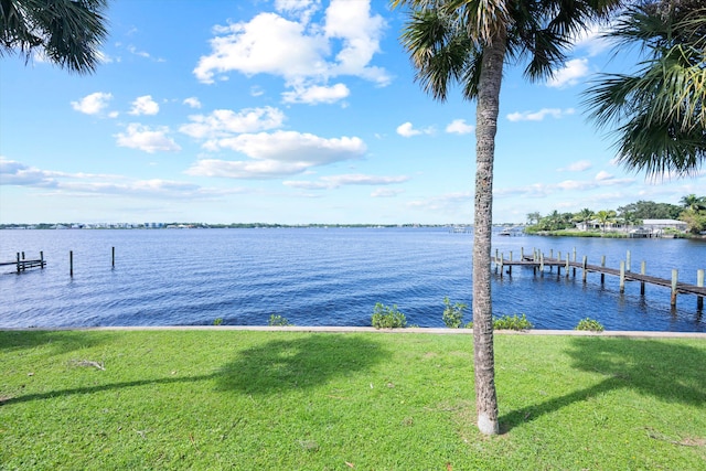 view of dock featuring a yard and a water view