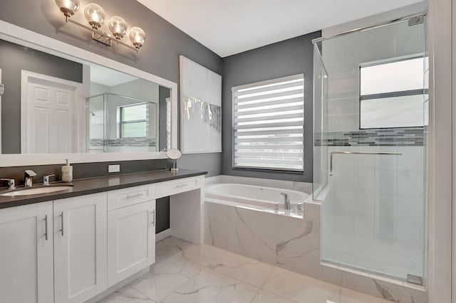 bathroom with vanity and shower with separate bathtub